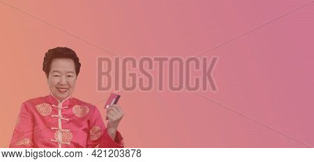 Chinese New Year Spending Credit Card. Asian Senior Woman In Constume Holding Red Card
