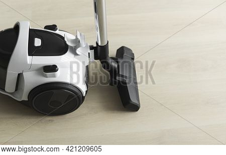 Bagless Cyclone Vacuum Cleaner On A Laminate. Electrical Apparatus That By Means Of Suction Collects