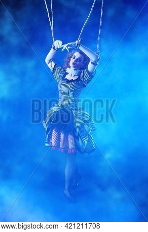 Puppet theater and circus. The actress plays a doll on strings at a performance in a puppet theater. Full length portrait in vintage style.