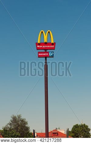 Mcdonald's Logo Sign On A High Pole In The October Revolution Street