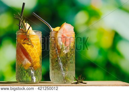 Summer Drinks Concept, Outdoor Cocktail Party. Hard Seltzer Cocktails With Grapefruit Slices And Ros