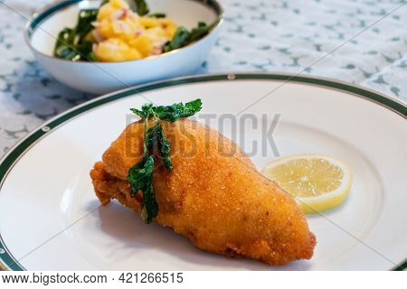 Viennese Fried Chicken Breast With Lemon Wheel And Fried Parsley