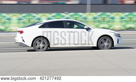 Moscow, Russia - March 2021: Kia K5 Dl3 On The City Road. Fast Moving White Shiny Korean Car On The 