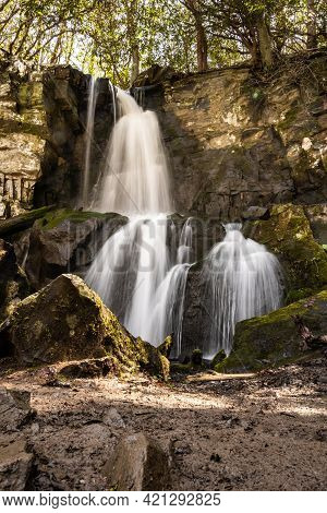Long Exposure Of Baskins Creek Falls And Mossy Boulders Guarding The Edge