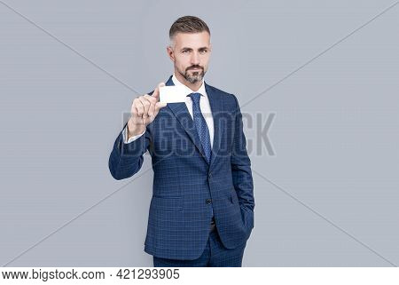 Mature Man With Grizzled Hair In Suit Showing Credit Or Debit Card Copy Space, Contact Us