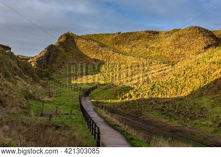 View Of The Path To The Dunnottar Castle Between Green Hills. Beautiful Sunny Morning. Stonehaven, A
