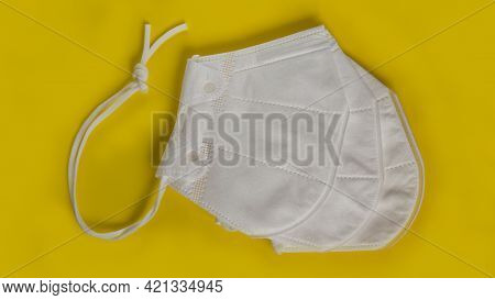 Set Of White Masks From Coronavirus On A Yellow Background