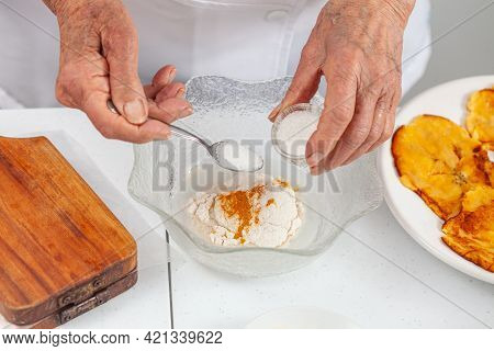 Senior Woman Preparing A Traditional Dish From El Valle Del Cauca In Colombia Called Aborrajado