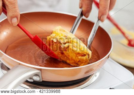 Senior Woman Preparing A Traditional Dish From El Valle Del Cauca In Colombia Called Aborrajado