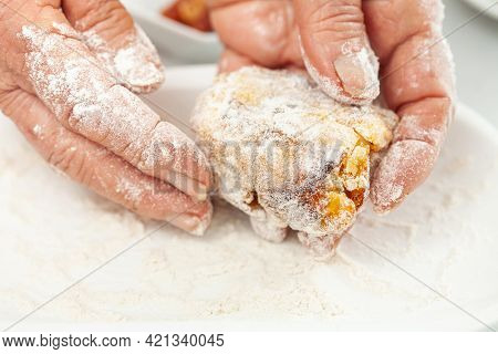 Senior Woman Preparing A Traditional Dish From El Valle Del Cauca In Colombia Called Aborrajado