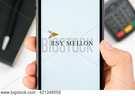 Bny Mellon Bank Logo On The Smartphone Screen In Mans Hand On The Background Of Payment Terminal, Ma