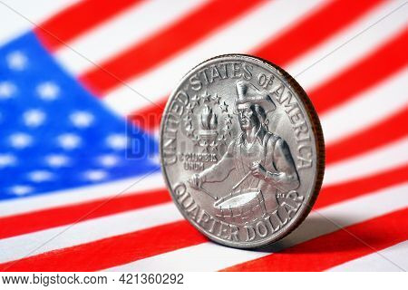 Us Quarter Dollar Coin With Drummer Close-up And Usa Flag. Stars And Stripes In The Blur. A Vivid Il