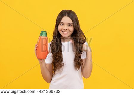 Smiling Child With Long Hair Hold Shampoo Bottle, Advert