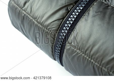 Close-up Zipper Closure On A Light Warm Olive-colored Jacket. Warm Clothes, Accessories For Outerwea