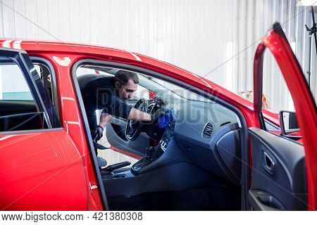 Car Service Worker Cleans Interiror With Steam Cleaner