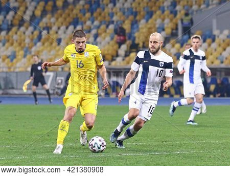 Kyiv, Ukraine - March 28, 2021: Vitaliy Mykolenko Of Ukraine (l) Fights For A Ball With Teemu Pukki 