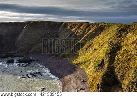 View Of The Coastline With Cliff And Beach At Castle Haven, Dunnottar Castle Area.stonehaven, Aberde