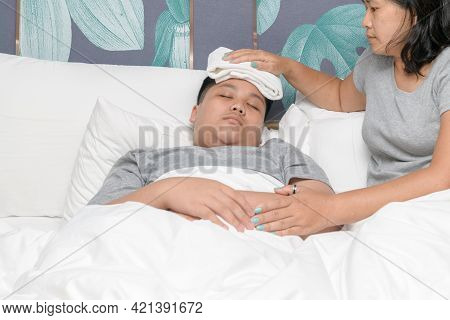 Asian Mother Wiped Son's Body To Reduce Fever In Bedroom, Concept Of Love And Healthy Care In Family