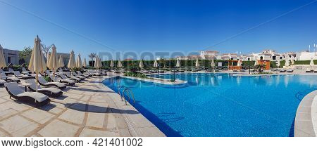 Panoramic View Of The Large Relaxation Area With Swimming Pool And Sun Loungers Near Red Sea In Hada