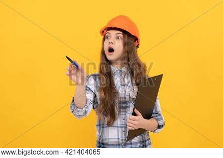 Shocked Teen Girl In Helmet And Checkered Shirt Making Notes On Clipboard, Working