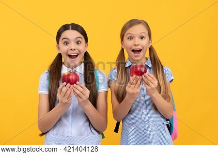Surprised School Age Kis Hold Tasty Organic Vitamin Apples Yellow Background, Healthy Food