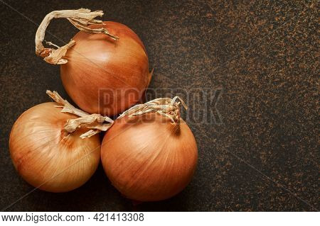 Three Fresh Bable Onions On A Dark Background With Copy Space, Macro