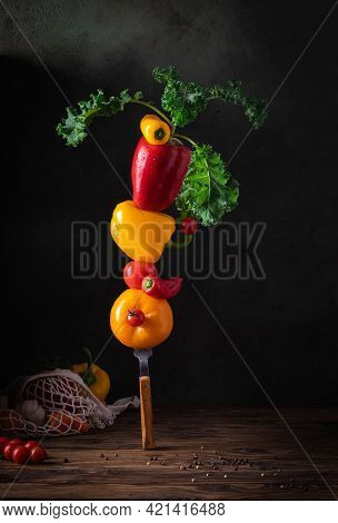 Fresh Vegetables For Summer Soup Piled Up Balancing On Fork On The Wooden Table