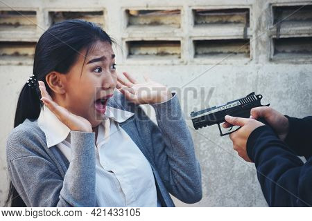 Thief Armed Man Rob Woman By Gun On Street So Scared Shocked Face. Frightened Asian Woman Was Rob Ag