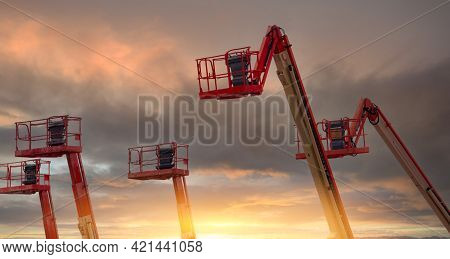 Articulated Boom Lift. Aerial Platform Lift. Telescopic Boom Lift With Sunset Sky. Mobile Constructi