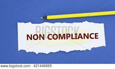 Non Compliance - Words On A Torn White Paper On A Blue Background. Info Concept