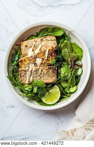 Fried Tofu With Green Salad And Nut Dressing In A White Bowl. Asian Cuisine, Vegan Food Concept.