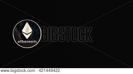 Ethereum Or Etherum Silver Coin On Black Background. Top View Of Eth Symbol With Space For Text.