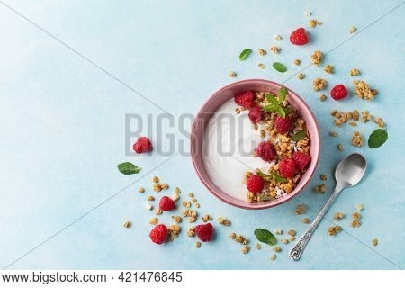 Bowl With Greek Yogurt, Raspberries And Granola. Top View Flat Lay. Healthy Nutrition Breakfast.