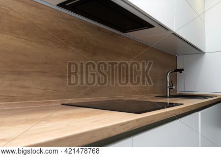 Modern Kitchen Interior With Induction Hob And Faucet With Sink