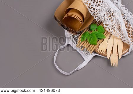 Close Up Of Eco-friendly Tableware - Kraft Paper Food Cups And Containers With Wooden Cutlery In Whi