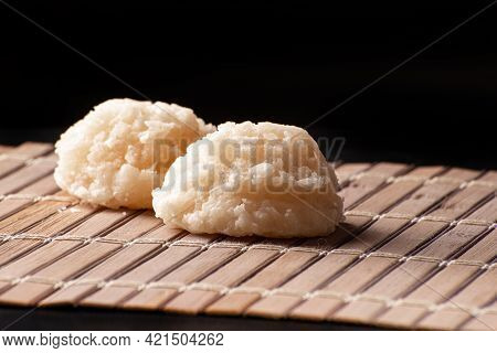Cocada, Coconut Candy From Brazil, White Cocadas On Wooden Mat, Black Background, Selective Focus.