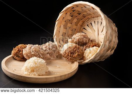 Cocada, Coconut Candy From Brazil, White And Brown Cocadas On Round Wood Fallen From A Straw Basket,