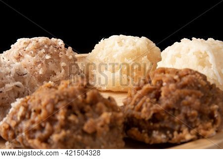 Cocada, Coconut Candy From Brazil, White And Brown Cocadas On Round Wood, Black Background, Selectiv