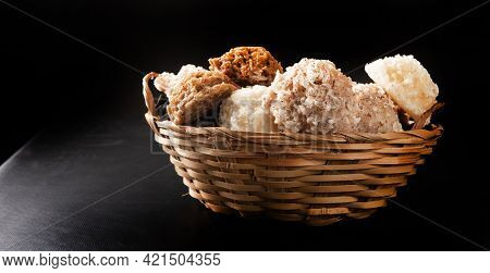 Cocada, Coconut Candy From Brazil, White And Brown Cocadas In A Straw Basket On Dark Surface, Black