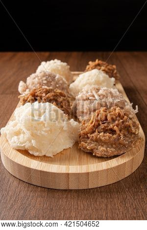 Cocada, Coconut Candy From Brazil, White And Brown Cocadas On Wooden Surface, Black Background, Sele