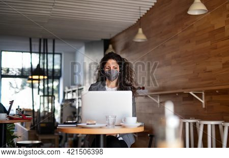 Businesswoman With Laptop Working In Cafe, Freelance Work And Coronavirus Concept.