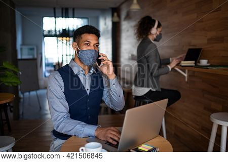 Business People With Laptop Working In Cafe, Small Business, Coronavirus And New Normal Concept.