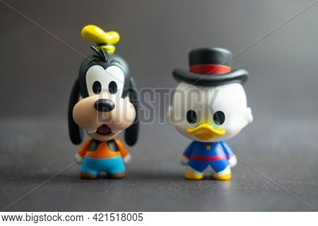 Samut Prakan, Thailand - May 24, 2021 : Cute Figurine Goofy And Scrooge Mcduck, Collection Figurine 