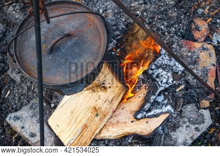 Top View Of Cooking Food In A Cauldron Over Campfire