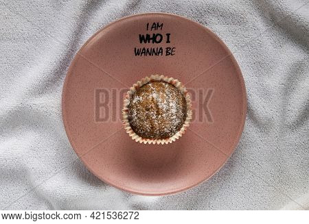 Freshly Baked Delicious Muffin On A Pink Plate
