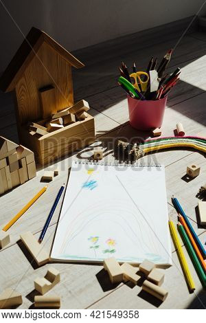 Rainbow Of Thread And Rope And Yellow Month. Children's Drawing In A Sketchbook. Cubes Are Wooden An