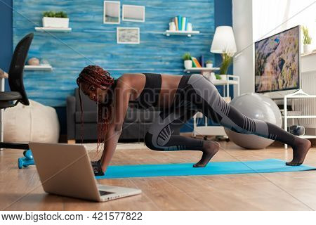 Black Fit Athletic Woman Training For Muscle Strenght Doing Mountain Climbers Position On Yoga Mat D
