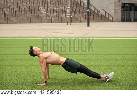 Sporty Man Making Back Plank Exercise. Guy In Reverse Plank Exercise. Yoga Fitness Man Stretching Bo