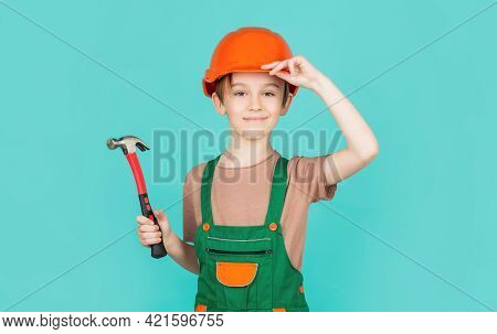 Little Builder In Helmet And Hummer. Child Dressed As A Workman Builder. Little Boy Wearing Helmet. 