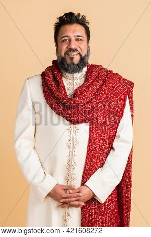 Happy Indian man wearing a kurta with a red scarf